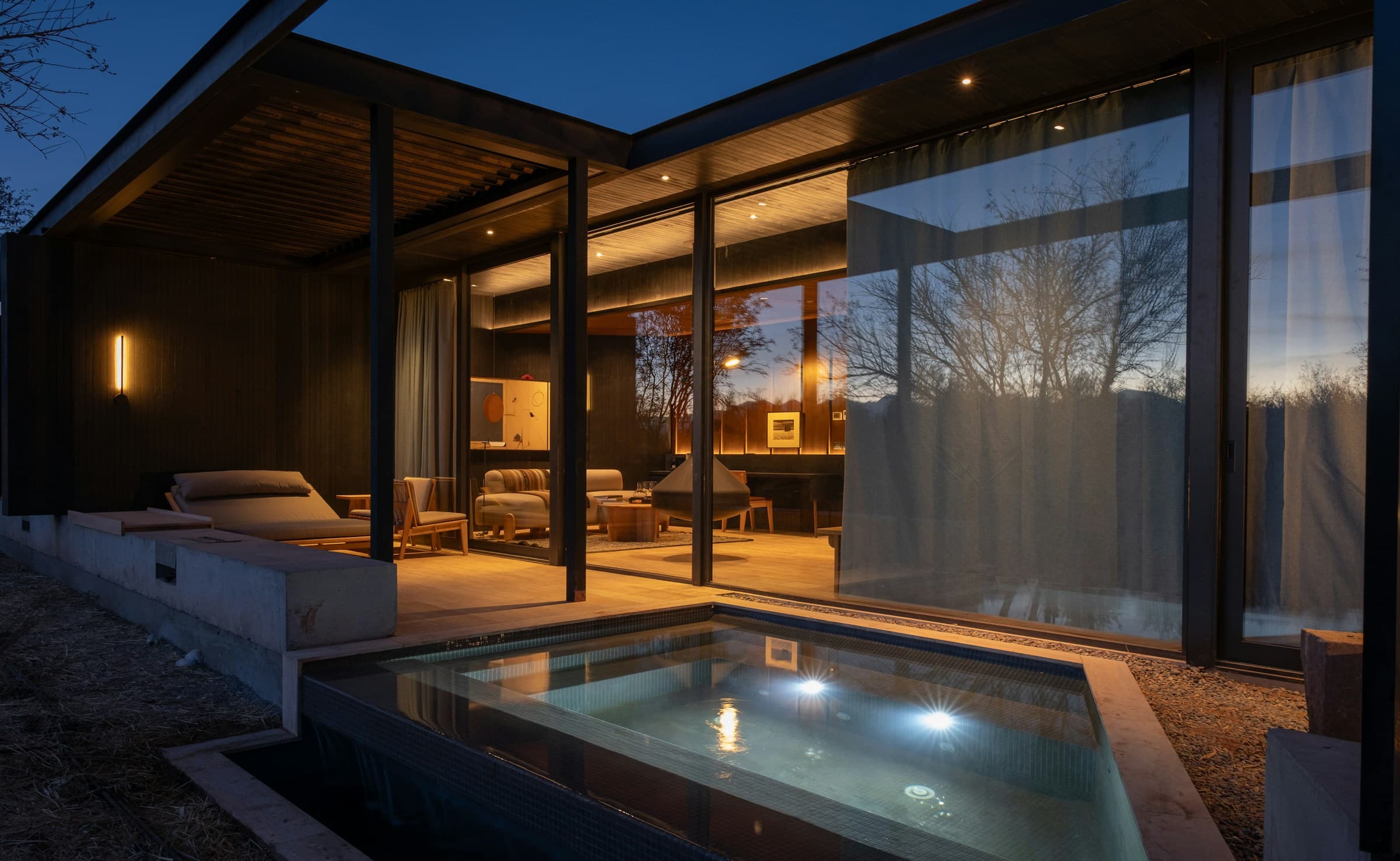 Modern residence with a terrace pool at dusk representing Ittehad Town Phase 1–3