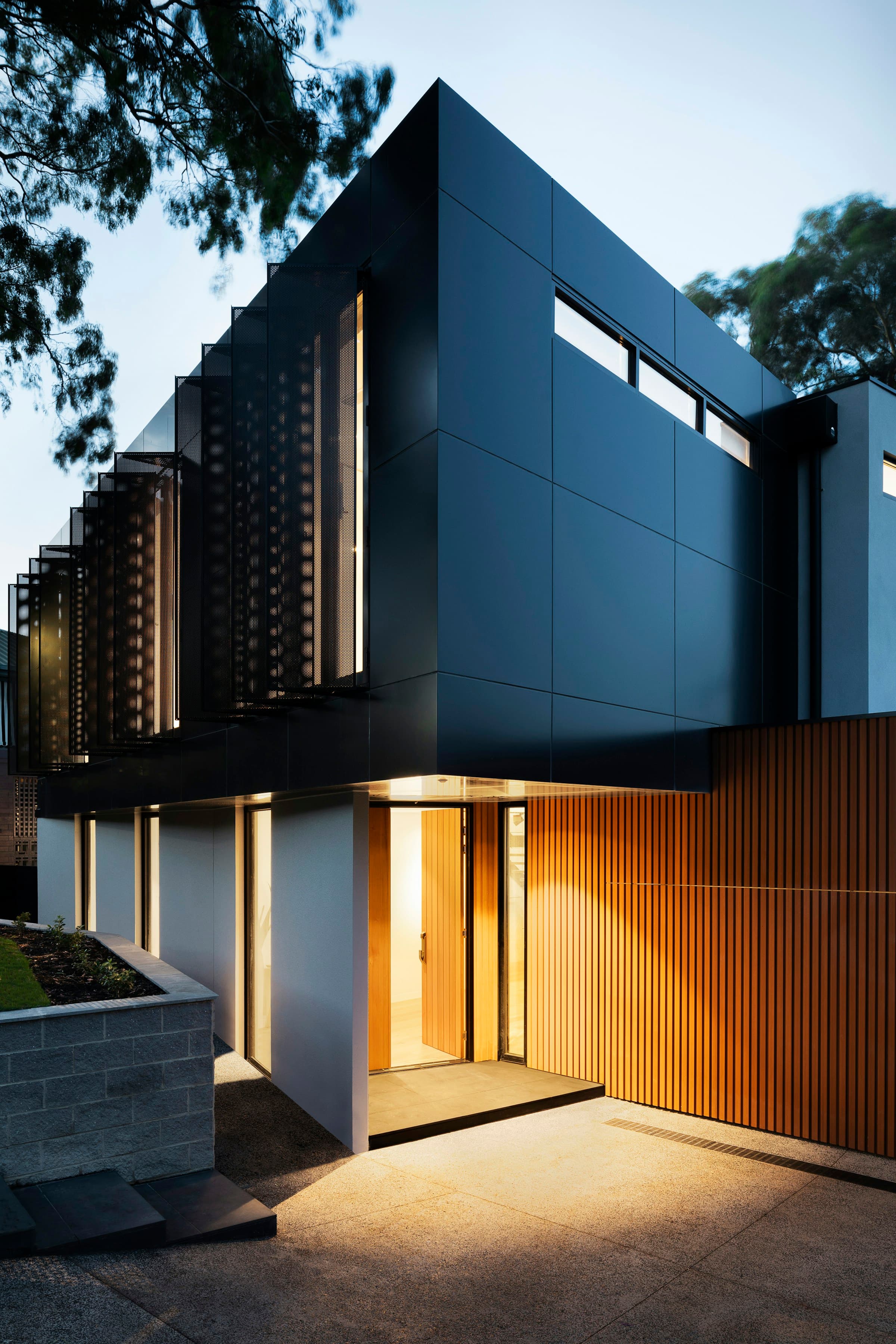 Modern residential building entrance lit at dusk representing Al Ghani Garden Phase 7